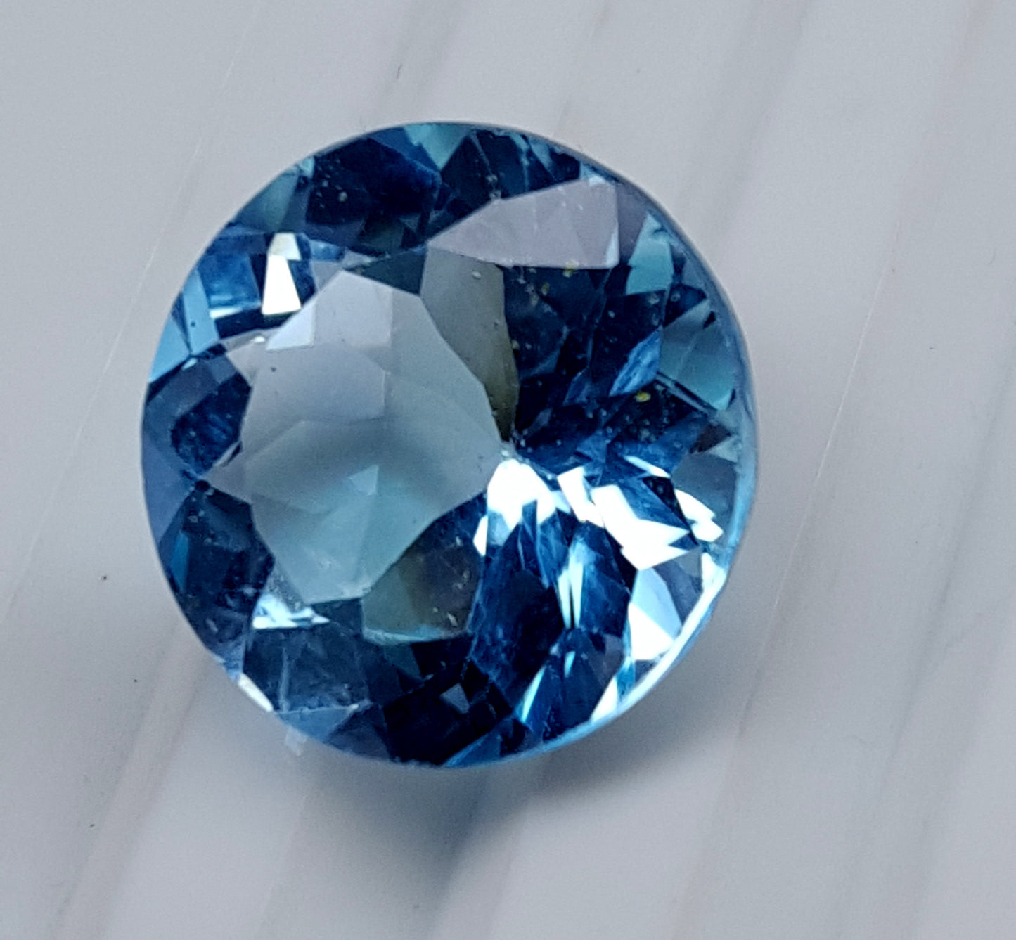 Blue Topaz round faceted gemstone, 13.50 carats, ideal for custom jewelry.
#BlueTopaz #LooseGemstone #FacetedGemstone #13.50Carat #TopazJewelry #NaturalTopaz #Gemstone